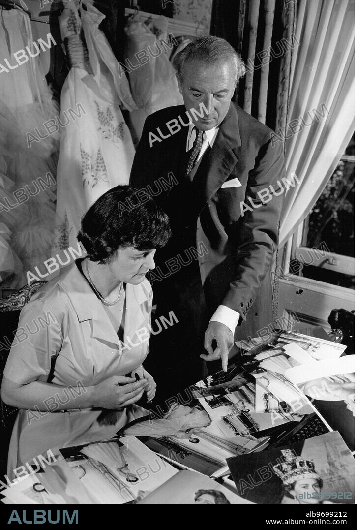 Cecil Beaton with his secretary Eileen Hose looking at photographs of Queen Elizabeth and Princess Margaret in the loft of an ancient barn at his home in Wiltshire 1956.