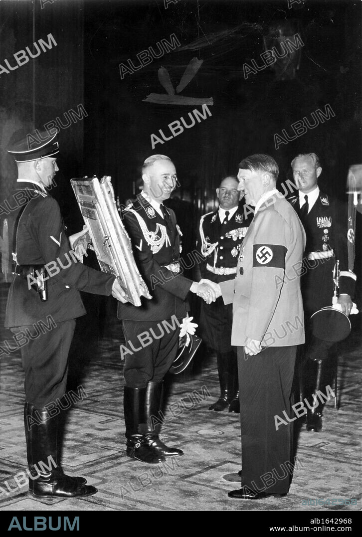 Heinrich Himmler shows Adolf Hitler a confiscated painting during World War II.