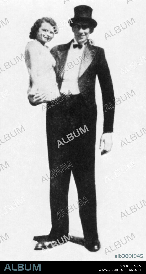 Al Tomaini (1912-1962), born as Aurelio Tomaini, with his wife, Jeannie the half girl. Jeannie Tomaini (1916-1999), born without legs, was only 2'6 (76 cm) tall. Tomaini was 7'4 (223.5 cm) tall. The pair worked in circuses and met at the Great Lakes Exposition in Chicago in 1936.
