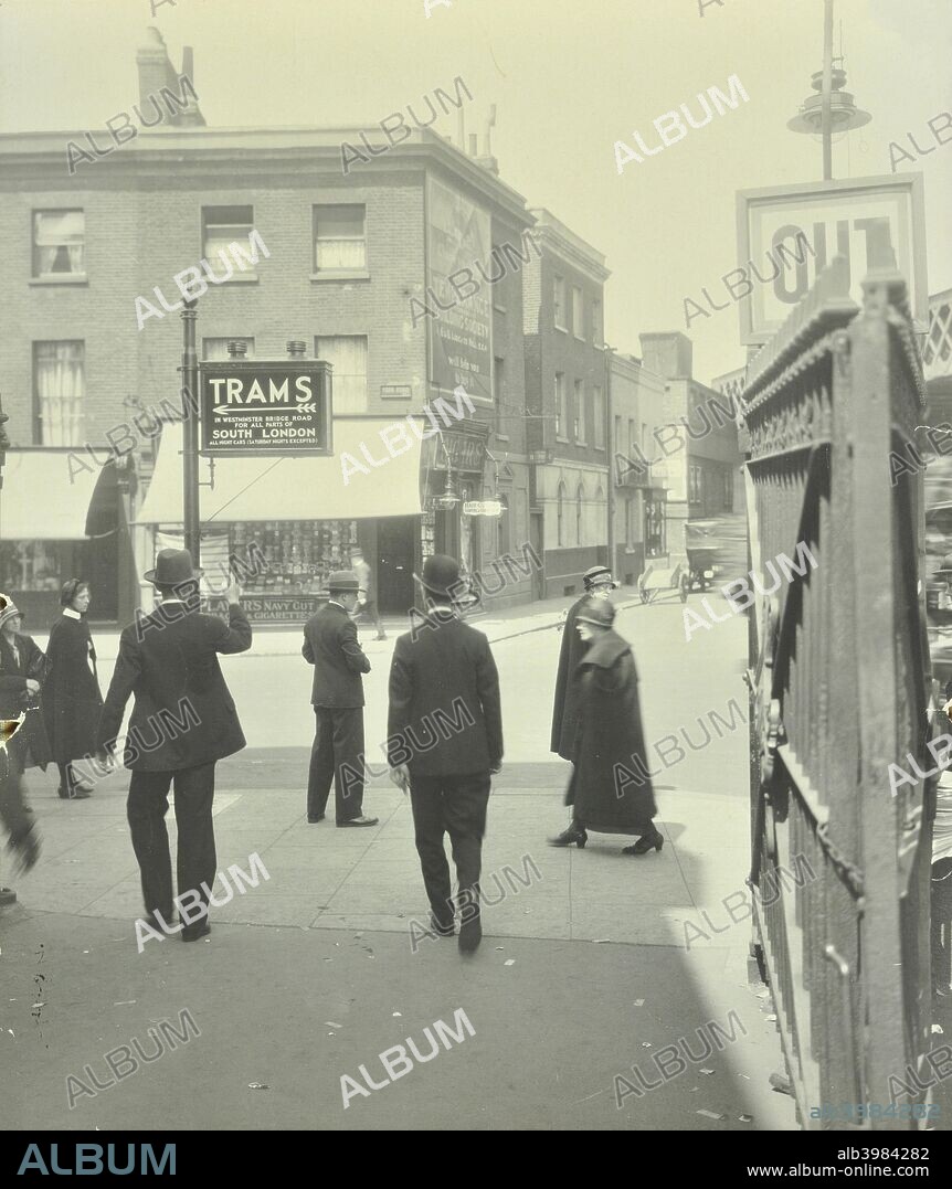 Pedestrians and tram sign outside Waterloo Station, Sutton Walk, Lambeth, London, 1929. Men emerging from the station entrance onto York Road by the sign directing people to trams in Westminster Bridge Road.