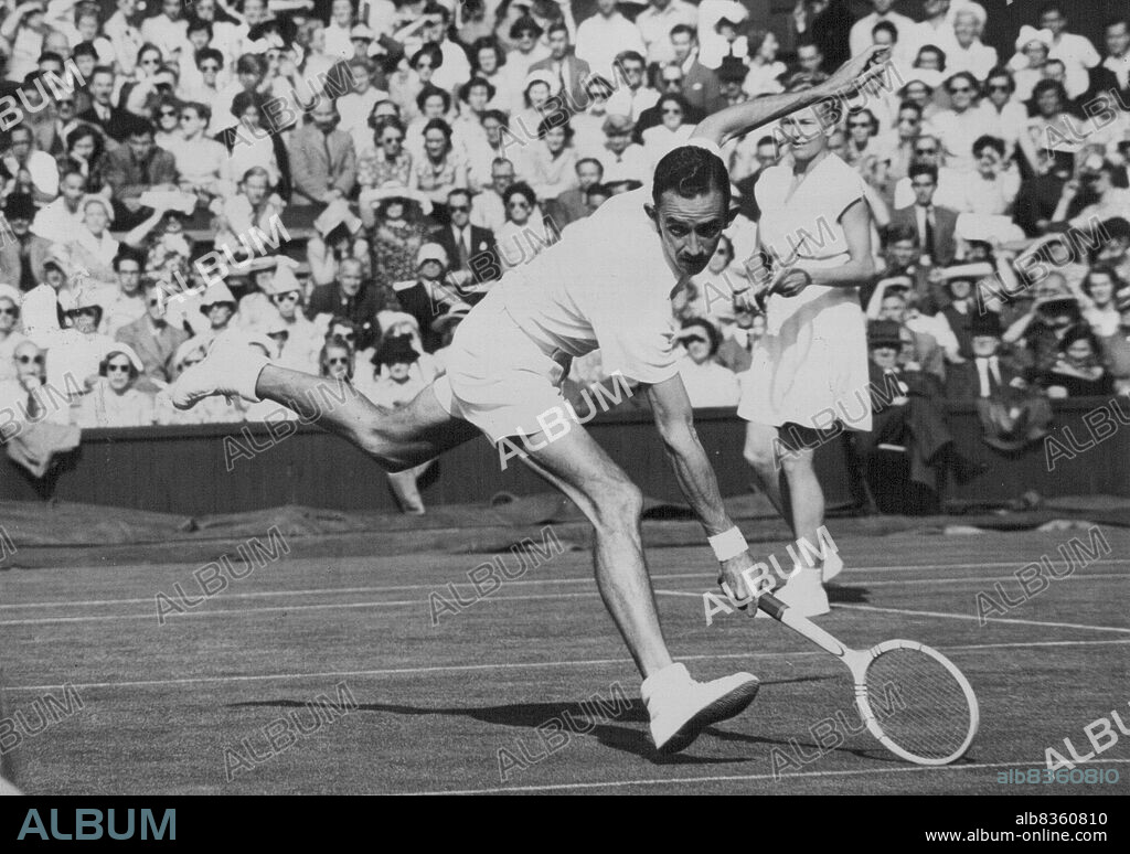 A Wimbledon Windmill - With arms and legs like the sails of a windmill, E.W. Sturgess of South Africa, reaches for a long shot during his Mixed Doubles match with Miss L. Brough of America against G.D. Lurie of South Africa end Miss S. Glietenberg (Australia) at the Wimbledon Tennis Championships. June 28, 1950. (Photo by Paul Popper Ltd.).