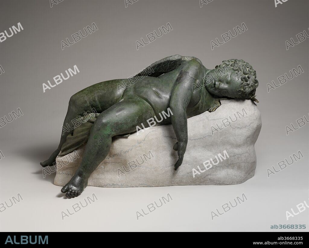 Bronze statue of Eros sleeping. Culture: Greek. Dimensions: 16 1/2 × 14 × 33 9/16 in., 275 lb. (41.9 × 35.6 × 85.2 cm, 124.7 kg)
Height (w/ base): 18 in. (45.7 cm). Date: 3rd-2nd century B.C..
The Hellenistic period introduced the accurate characterization of age. Young children enjoyed great favor, whether in mythological form, as baby Herakles or Eros, or in genre scenes, playing with each other or with pets. This Eros, god of love, has been brought down to earth and disarmed, a conception considerably different from that of the powerful, often cruel, and capricious being so often addressed in Archaic poetry. One of the few bronze statues to have survived from antiquity, this figure of a plump baby in relaxed pose conveys a sense of the immediacy and naturalistic detail that the medium of bronze made possible. He is clearly based on firsthand observation. The support on which the god rests is a modern addition, but the work originally would have had a separate base, most likely of stone.  
This statue is the finest example of its kind. Judging from the large number of extant replicas, the type was popular in Hellenistic and, especially, Roman times. In the Roman period, Sleeping Eros statues decorated villa gardens and fountains. Their function in the Hellenistic period is less clear. They may have been used as dedications within a sanctuary of Aphrodite or possibly may have been erected in a public park or private, even royal, garden.