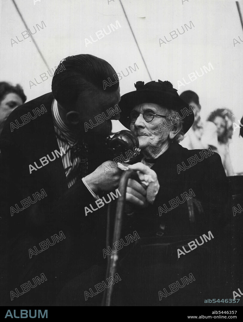 Pickles Party -- Mrs. Burgess tells the world she is "going 91", under Wilfred's persuasive influence. She has lived in St. Helens since she was 22, it comes out, and she has been going to bible class for fifty years, and enjoying the annual treats for as long. Wilfred hopes she'll enjoy many more. July 22, 1948. (Photo by Pictorial Press).
