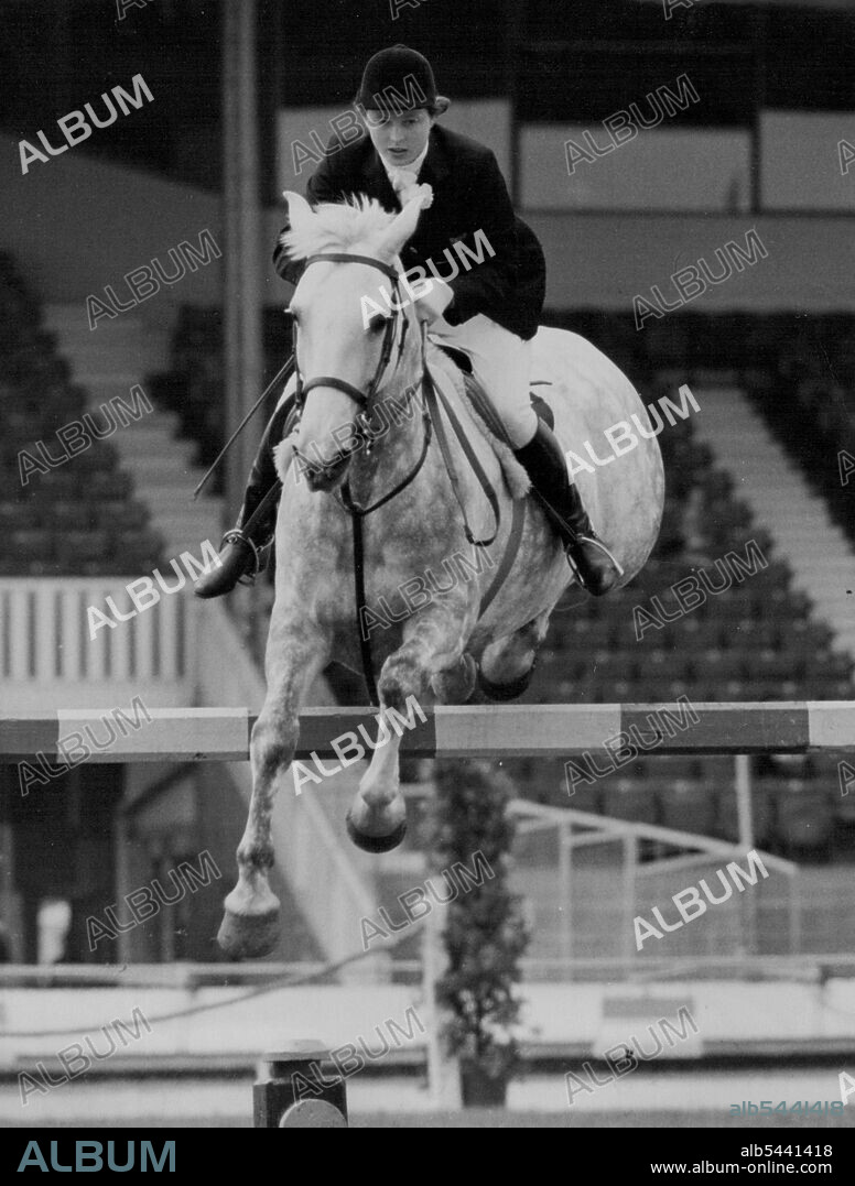 Pat Smythe - And Tosca Take A Jump At International Horse Show -- Miss Pat Smythe, Britain's leading horsewoman, taking a jump on her famous mare Tosca in the Ladies' Debutants international jumping competition at the International Horse show, White City Stadium, London, today (Monday). The event was won by Mlle. J. Bonnaud of France on Charleston. The show opened to-day until Saturday. July 19, 1954. (Photo by Reuter Photos).