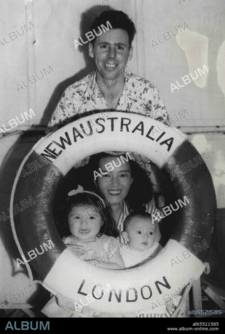 Sgt. James Perkins holds a life belt over his Jap wife and two children. Wife's name "Sueko" children Eileen 2 years James 3/Months they will live in Melbourne. April 08, 1953.