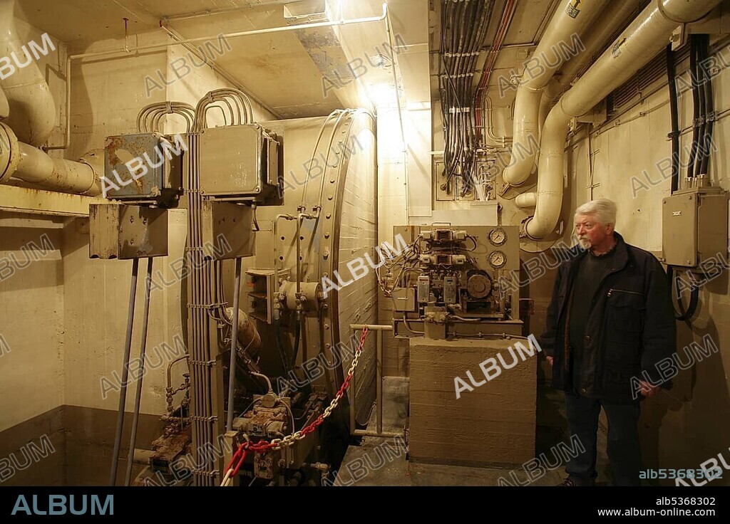 Employees observing the control room in the museum of the former Marienthal government bunker near Ahrweiler, Rhineland-Palatinate, Germany, Europe