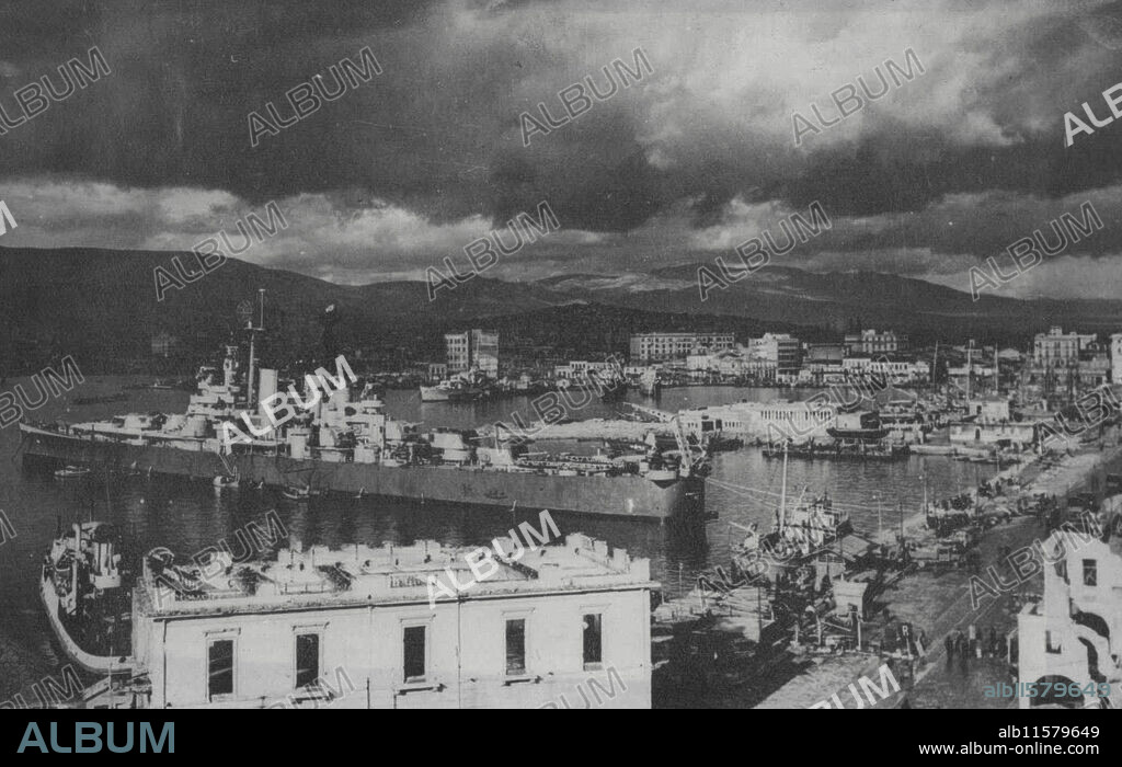 First US Warship Visits Piraeus - A fine view of the Piraeus, the Port of Athens, main gateway for the flow of supplies to Greece. In foreground is the American cruiser providence which recently made a courtesy call. Providence was the first American warship to visit Greece since the beginning of the war. January 24, 1946. (Photo by Associated Press Photo).
