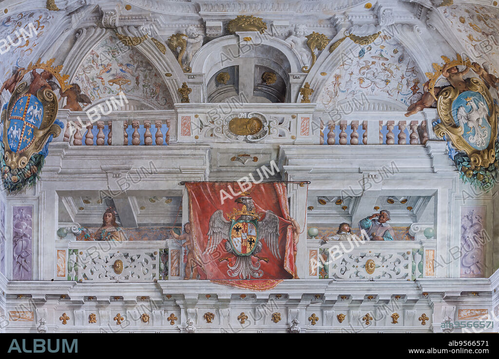 Sassuolo, Este Ducal Palace; Hall of the Guards: the hall with the Bologna Quarters by Angelo Michele Colonna, Agostino Mitelli, Baldassarre Bianchi and Gian Giacomo Monti. Detail of the south-west wall, with the coat of arms of the Este family and a balcony with figures, including a man with glasses.