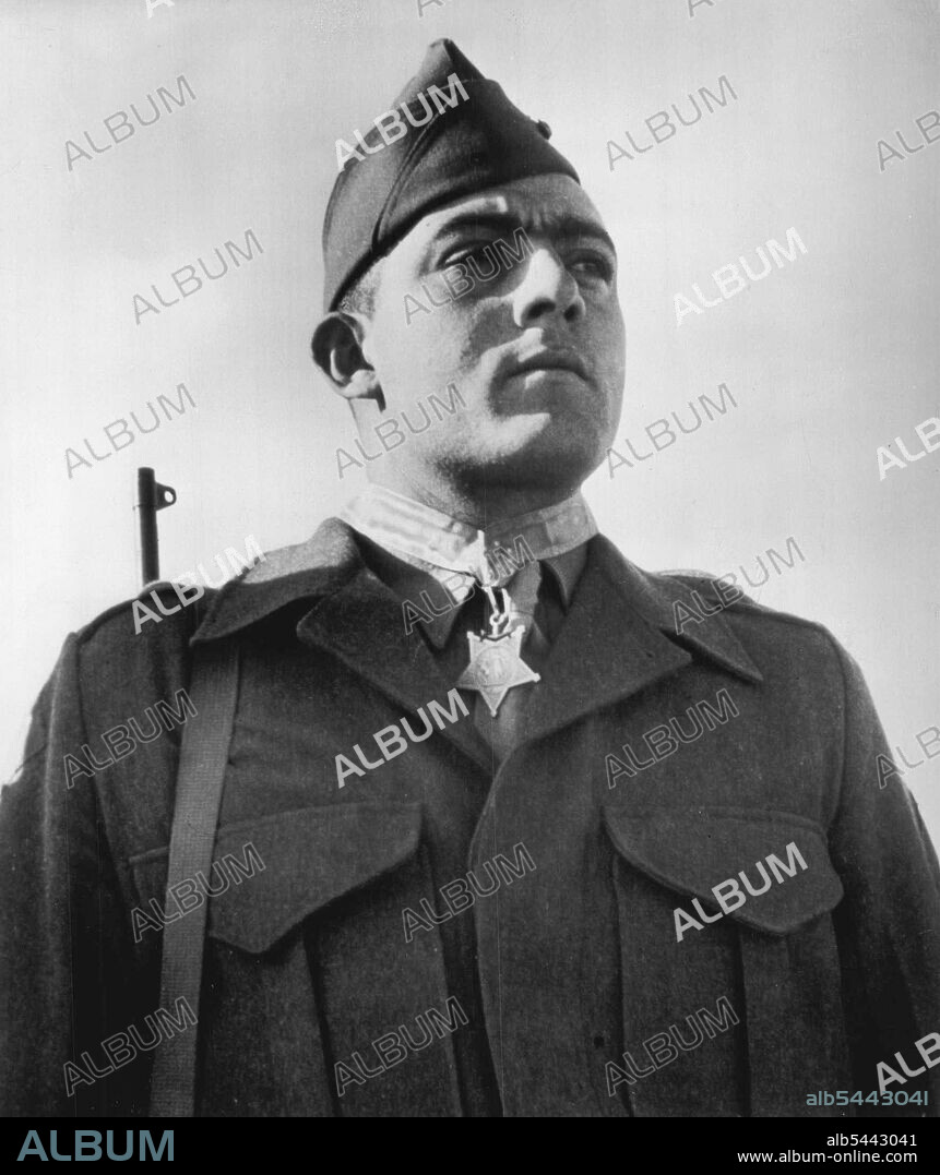 Wins Congressional Medal Of Honor -- Marine Platoon Sergt. "Manila John" Basilone, of Raritan, N.J., 26-year-old Marine officially credited with mowing down 38 Japs in the virtual annihilation of an entire Japanese regiment in the Lunga Point area of the Solomons Island, October 24-25, proudly wears the Congressional Medal of honor which he received for his "Extraordinary Heroism". June 24, 1943. (Photo by AP Wirephoto).