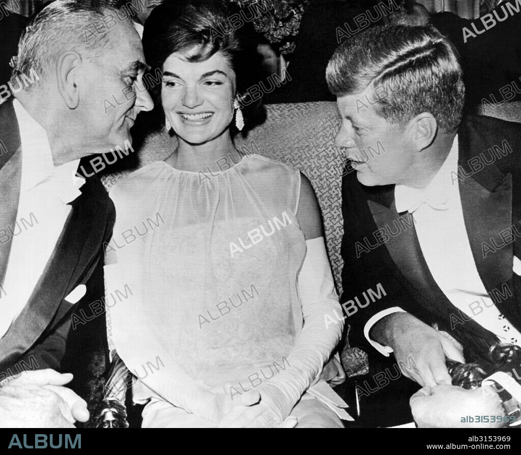 Washington, D.C.:   February 2, 1961 Vice President Lyndon Johnson leans over Jacqueline Kennedy to listen to President John Kennedy at the inaugural ball after their election to office.