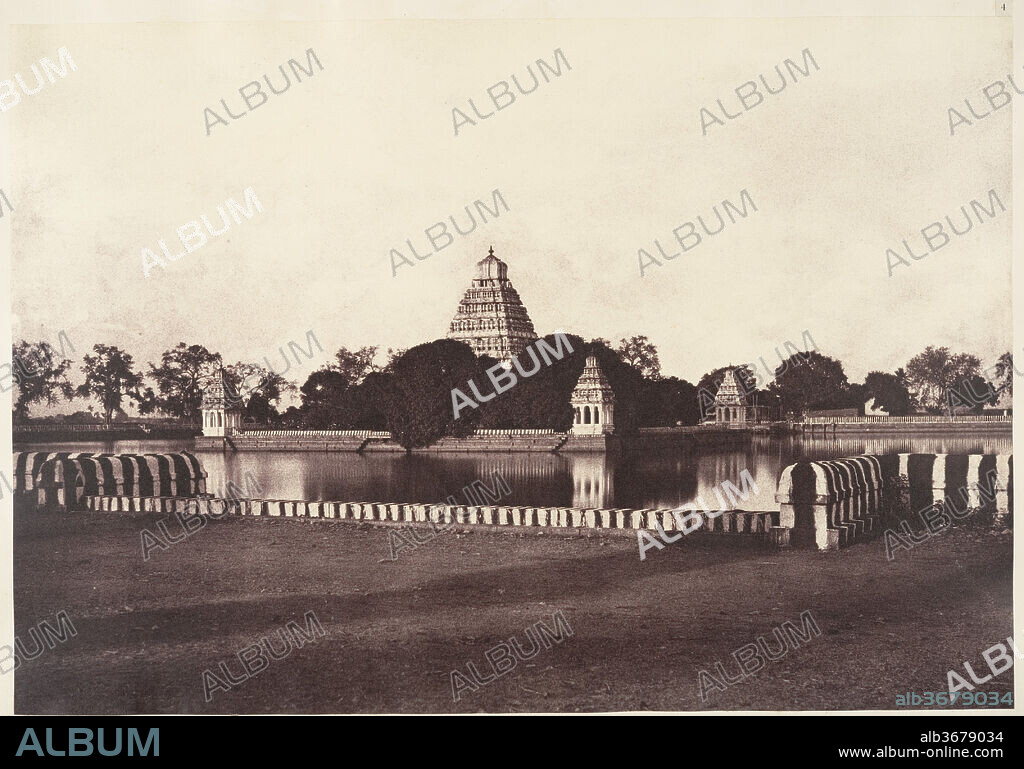 The Teppa-kulam. Artist: Linnaeus Tripe (British, Devonport (Plymouth Dock) 1822-1902 Devonport). Dimensions: Image: 26 x 37.5 cm (10 1/4 x 14 3/4 in.)
Mount: 45.2 x 56.2 cm (17 13/16 x 22 1/8 in.). Date: 1858.
Tripe was a career military officer in India and, in the late 1850s, government photographer to the Madras Presidency. In just five years he made nearly one thousand views of India and Burma.  
In this view of a teppakulam, or tank, in Madurai, South India, the mirror-like surface of the water reflects the stripes of the surrounding stone wall.  In the accompanying text, Tripe explained that during an annual Hindu festival, likenesses of the god Sundareshwara and goddess Minakshi were rowed around in "a gaily decorated raft," and then brought inside the pavilion, whose intricately carved central tower rises from a mass of dense foliage.