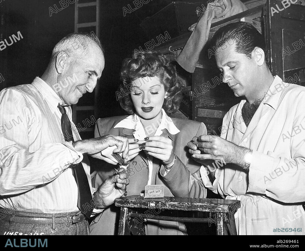GEORGE MARSHALL, LUCILLE BALL and WILLIAM HOLDEN in MISS GRANT TAKES RICHMOND, 1949, directed by LLOYD BACON. Copyright COLUMBIA PICTURES.