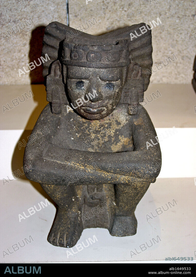 seated figure of Xiuhtecuhtli the Aztec goddess of Fire. AD 1325-1521 From Mexico. This figure represents Xiuhtecuhtli, the Mexica god of fire. Xiuhtecuhtli is generally represented nude except for a loin cloth, with eyes semi-closed and only two teeth protruding from the corners of his mouth (characteristic of the old god Huehueteotl, with whom he is also identified).