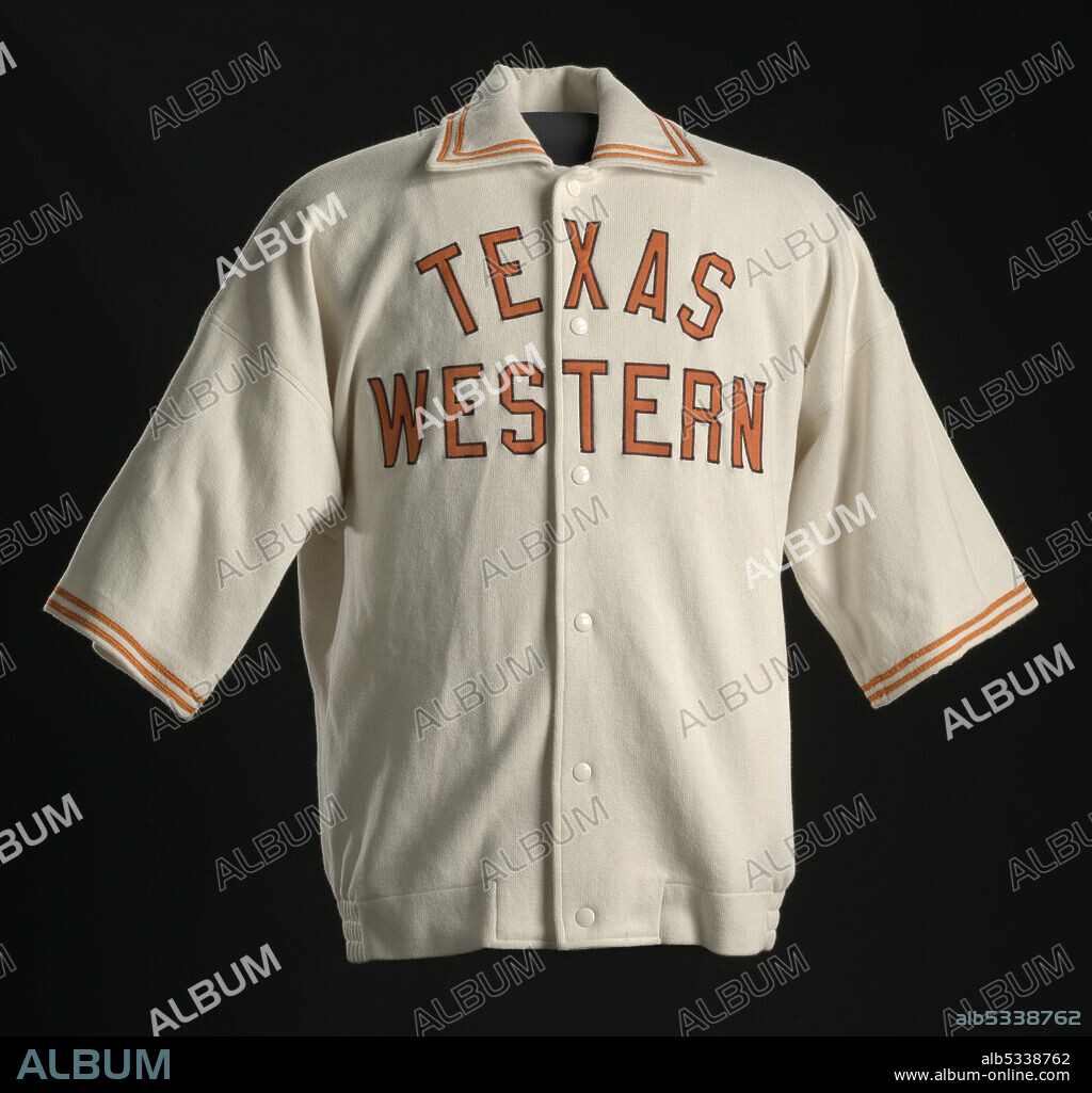 Jerry Armstrong played for the Texas Western College Miners basketball team at El Paso, USA. In 1966, the team used the first all-black line-up to win a National Collegiate Athletic Association Tournament. White basketball warm up jacket with orange details and short sleeves, fastens up the center-front with metal snaps. There are orange double stripe accents around each cuff and the lapel. The type on the front of the jacket reads: [TEXAS / WESTERN] in orange letters. The upper back of the jacket has a rectangular padded section with six metal snaps.
