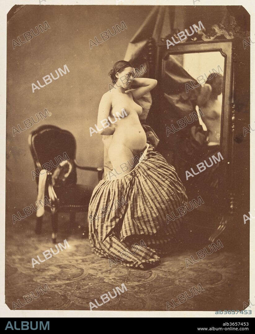 [Nude Before a Mirror]. Artist: Attributed to Bruno Braquehais (French, 1823-1875). Dimensions: Image: 22.3 × 17.9 cm (8 3/4 × 7 1/16 in.)
Mount: 50.1 × 39.3 cm (19 3/4 × 15 1/2 in.). Date: ca. 1857.
Académies, or nudes intended for use as preparatory studies for other artworks, were one of the most prolific forms of photography after the medium's invention in 1839. Trained as a lithographer, Braquehais registered his first photographs for sale in 1854. Through the use of elaborate props, soft lighting, and poses based on classical statues, he elevated erotic imagery to the realm of the artistic, as defined by watchful state censors. Despite the provocative nature of this photograph, it would have been deemed acceptable due to its overt references to the established visual tradition of women at their toilettes.