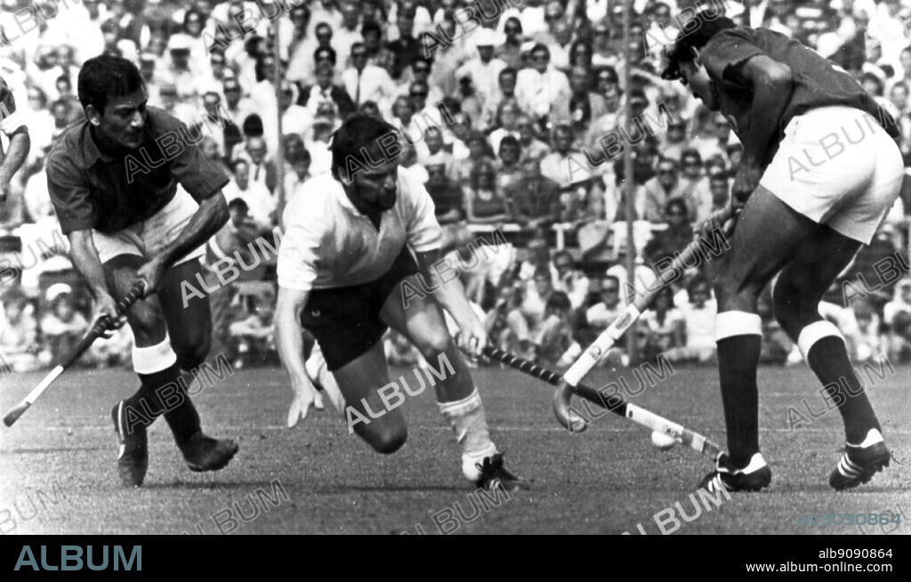 September 1972: Munich Olympics: Germany win the Men's hockey versus Pakistan in the final by 1-0. West Germany's Uli Vos, at centre, goes past Riaz Ahmed and Akhtarul Islam.
