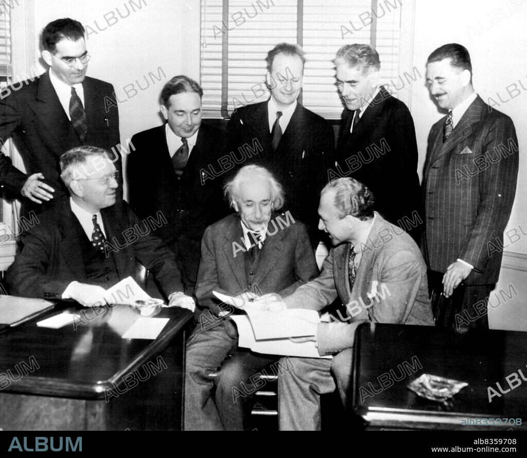 Atomic Scientists Meet  - Members of Emergency Committee of Atomic Scientists discuss here today contents of their joint appeal issued for public subscription of $1,000, 000 to finance a nation-wide educational campaign on social implications of atomic energy Left to right are: Seated, Harold C. Urey, Univ. of Chicago, Prof. Albert Einstein; Selig Hecht, Columbia University; standing, Victor F. Weisskopf, Massachusetts. Institute of Technology; Lee S. Szilard, Univ.of Chicago; Hans A. Bethe, Cornell University; Thorfin R. Hogness, Univ. of Chicago and Philip M. Morse, on leave from M.I.T. November 17, 1946. (Photo by AP Wirephoto).
