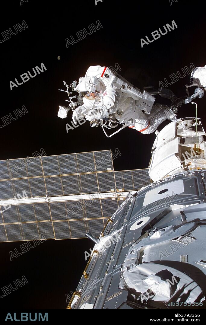 Astronaut Jerry L. Ross takes a picture during a 7-hour, 21 minute spacewalk. Astronauts Ross and James H. Newman connected cables from the Zarya control module to the Unity node, with the 35-ton complex towering over Endeavour's cargo bay during STS-88, the first mission of the Space Shuttle to the International Space Station, December, 1998.
