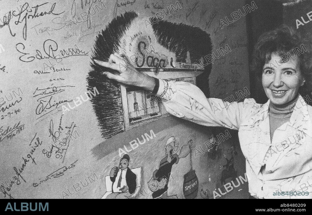 GÖTEBORG 1980-tal.. Biografen Saga på Sofiagatan i Härlanda - Marianne Vogl visar den berömda väggen där man finner autografer från berömt filmfolk från 1950-talet. ŒŠš€… *** Local Caption *** Bilden inscannad från Biografboken som Landsarkivet gav ut. Foto: Kamerareportage / TT / Kod: 2524.