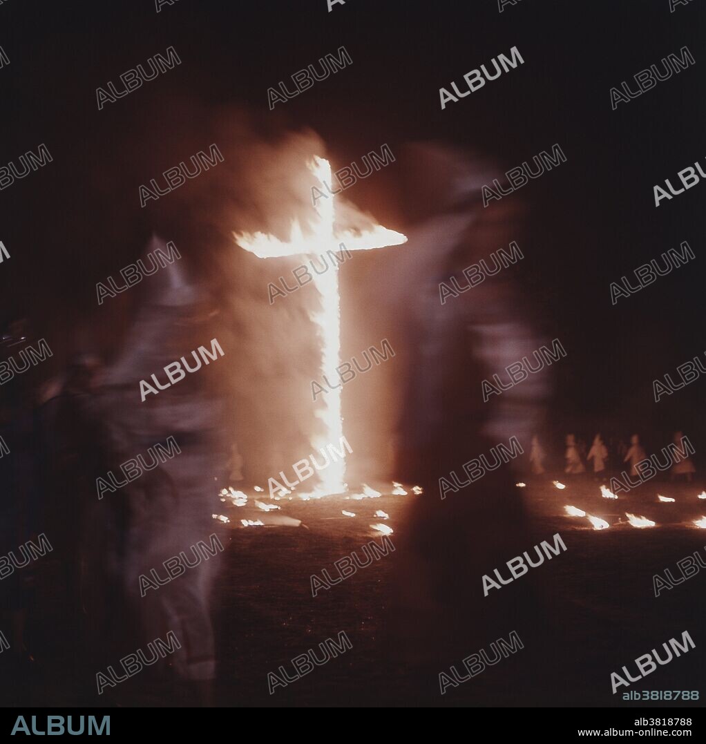 A cross burning at a Ku Klux Klan (KKK) meeting near Greenboro, North Carolina, mid-1960s.