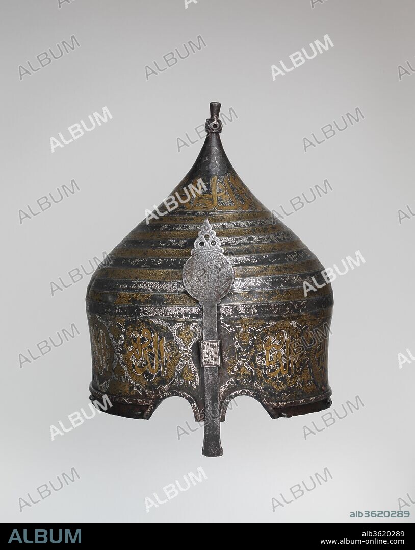 Turban Helmet. Culture: Western Iranian, in the style of Turkman armor. Dimensions: H. 11 1/2 in. (29.2 cm); Wt. 3 lb. 5 oz. (1496 g). Date: late 15th century.
Helmets of this type are usually called turban helmets because of their large bulbous shape and the flutings that imitate the folds of a turban. Because certain dervish groups wore turbans wound with a prescribed number of folds to represent an important mystical number, it is likely that turban helmets were regarded not merely as armor but also a kind of religious insignia, their very shape marking the wearer as a fighter in the Holy War. Turban helmets, together with mail-and-plate armor of matching decoration, were intended for the heavy cavalry and are recorded as early as the fourteenth century. This example appears to have belonged to the dynasty of the Ak-Koyunlu (White Sheep Turkoman) that ruled northwestern Iran and Anatolia in the fifteenth century. The inscriptions, damascened with gold and silver, glorify temporal rulers, wish the owner well, or give advice on how to attain virtue.
