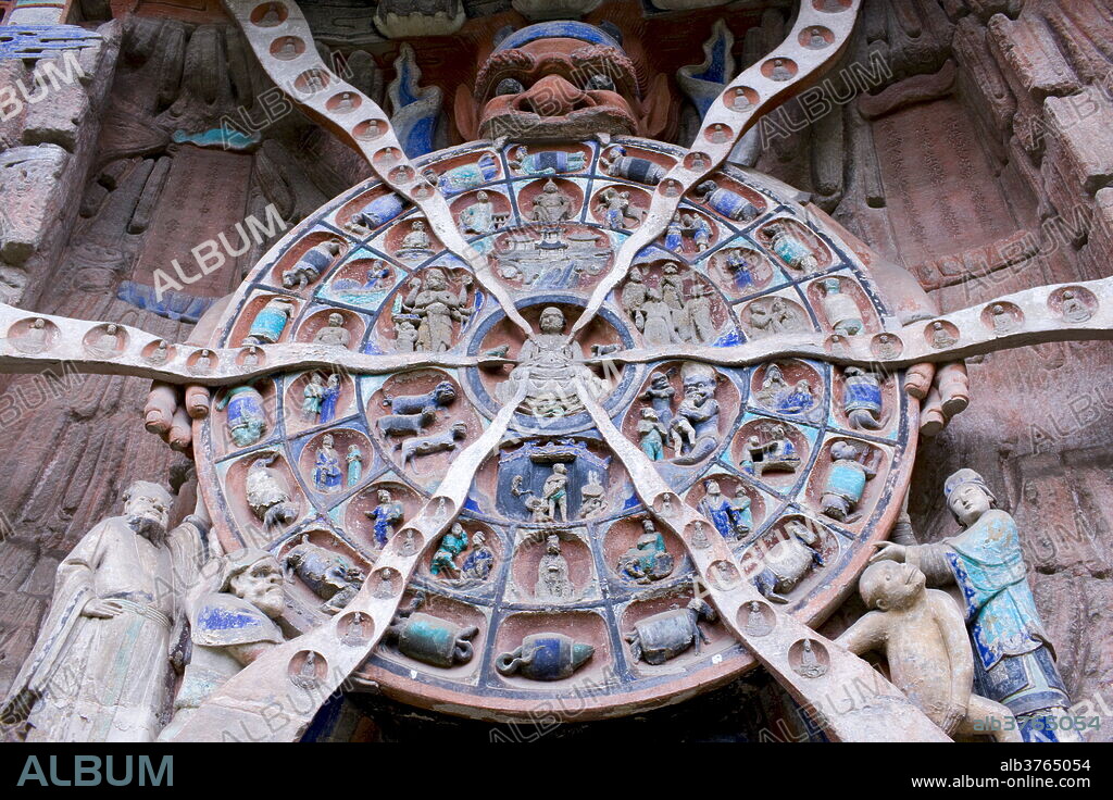 Anicca, God of Destiny holds wheel of life of Buddhist Karma, Dazu rock carvings, Mount Baoding, China.