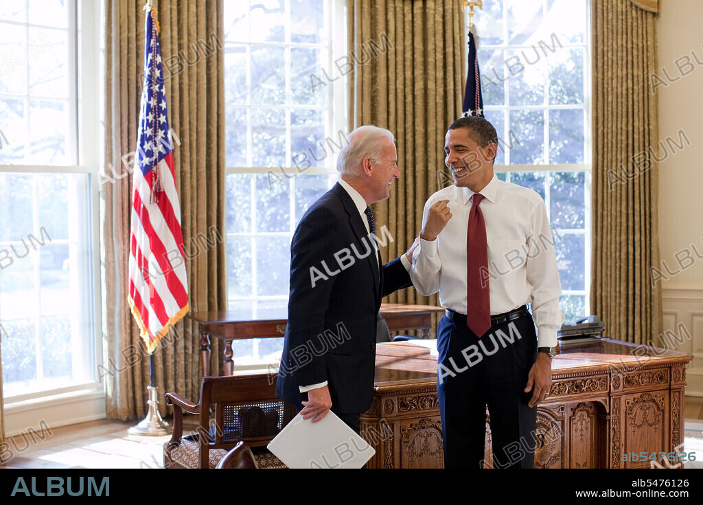 President Barack Obama and Vice President Joe Biden laugh together in the Oval Office, 1/22/09. .
