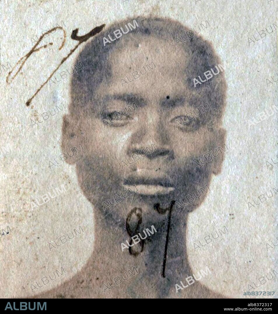 This photograph of a 'Liberated African' slave was taken after they were freed from slaving ships by the British Navy. From 1861 to 1874, more than 2500 'Liberated Africans' were shipped to Port Victoria, Seychelles.<br/><br/>. While the Slave Trade continued across eastern and southern Africa and the Indian Ocean, the 'liberated' were taken to a depot, classified by the District Magistrate, photographed, renamed, and assigned as 'apprentices' to the French-owned plantations, where they were indentured for five years.
