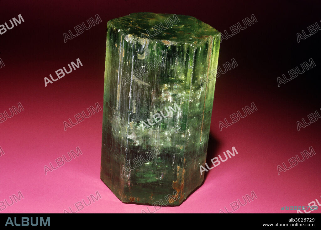Beryl is composed of beryllium aluminum silicate and is the chief ore of the element beryllium. Crystals of beryl in certain unique rocks called pegmatites can be as large as railroad boxcars. These immense crystals are never transparent, but some pegmatites contain smaller, well formed and transparent beryl crystals; these occur in various colors, and each variety used as a gemstone has its own special name. The green variety is called simply green beryl. This is very different from the unique dark green variety known as emerald. Large fine beryl crystals occur in Brazil, Russia, Madagascar and many other places. The hexagonal (6-sided) symmetry of the mineral is evident in this crystal from Mursink, Russia.
