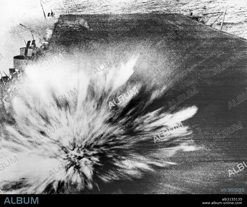 Pacific Ocean:  October 15, 1945. A Japanese bomb explodes on the flight deck of the USS Enterprise, killing the photographer, Phom 3/c Robert Read, but the film survived.