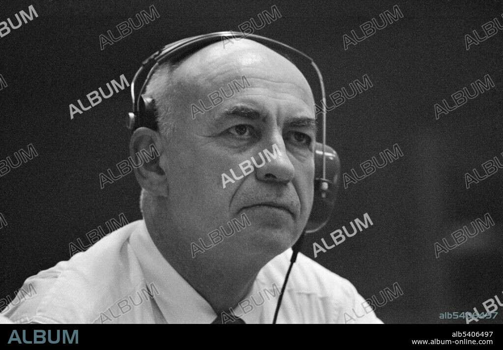 Gilruth keeps up with progress of the historic Apollo 11 lunar landing mission from his console in Houston's Mission Control Center. Robert Rowe Gilruth (October 8, 1913 - August 17, 2000) was an American aerospace engineer. In 1937 Gilruth was hired at NACA’s Langley Memorial Aeronautical Laboratory, where he performed flight research and pioneered the recording of data from instruments during flight test, to be later correlated with the pilot's experience. Gilruth became involved in the transition of NACA into NASA. When NASA was created, Gilruth became head of the Space Task Group, tasked with putting a man in space before the Soviet Union. When President Kennedy announced that America would put a man on the Moon before the end of the decade in 1961, Gilruth was unsure that such a goal could be accomplished. He was integral to the creation of the Gemini program, which he advocated as a means for NASA to learn more about operating in space before attempting a lunar landing.  Soon the Apollo program was born, and Gilruth was made head of the NASA center which ran it, the new Manned Spacecraft Center (MSC) (now the Johnson Space Center) and served as director of the MSC until his retirement in 1972. He oversaw a total of 25 manned space flights, from Mercury-Redstone 3 to Apollo 15.  Gilruth died in 2000 at the age of 86.