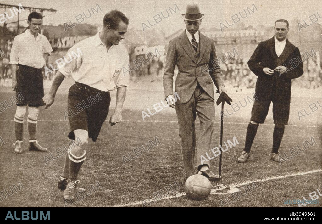 'The Duke of York kicking off a charity football match between Tottenham Hotspurs and Corinthians', c1921. From Our King & Queen and the Royal Princesses. [Odhams Press Ltd., London, 1937].