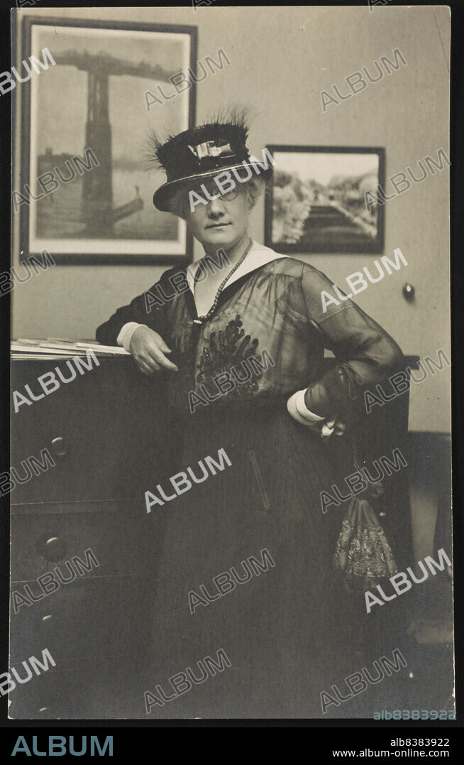 Mattie Edwards Hewitt, between 1911 and 1917. Mattie Edwards Hewitt, three-quarter length portrait, standing, facing front, right arm on chest of drawers. [Photographer. Established the Johnston-Hewitt Studio in New York City in 1913 with fellow photographer Frances Benjamin Johnston, who later became her lover. They lived and worked together for eight years].