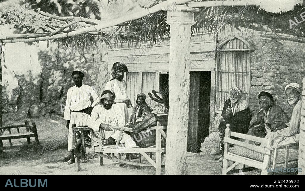 Historical Geography. 1900. In the cool evening the men of the vicinity who have borne the day's burden and heat find pleasure in relaxation by the gliding river, whose changeless flow forms a soothing accompaniment to the murmur of easy conversation. On the veranda, with its rude seats and thick-thatched roof, the coffee, a delicacy of which the Arab never tires, and the fragrant fumes of tobacco have an added delicacy of flavour.