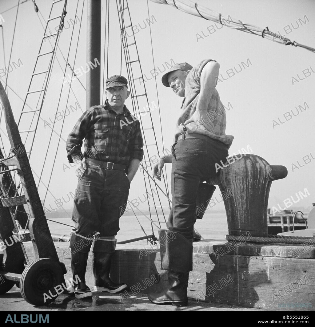 GORDON PARKS. New York, New York. New England fishermen resting on the Fulton docks.
