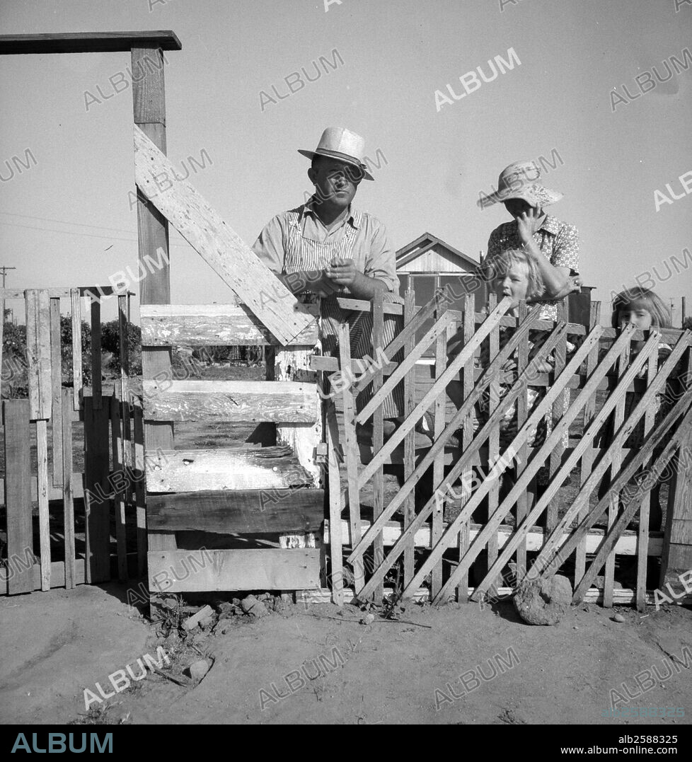 Highway City, California, near Fresno. Family from Oklahoma; have been in California for six years, have been migratory workers now on Works Progress Administration (WPA) from which they may be cut off at the opening of the 19390101 harvest. Their house represents one of many similar structures, which they are attempting to construct by their own efforts on poor land, for which they are paying a few dollars a month out of the WPA budget. Their light bill is two dollars a month. Water bill one dollar a month, kerosene for cooking five dollars per month by Dorothea Lange 1895-1965, dated 19390101.