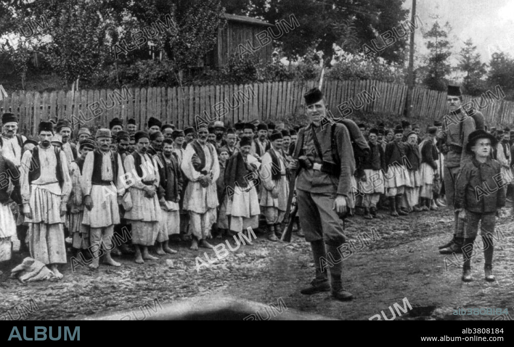 Large group of Serbian soldiers, most are barefoot, captured at Kreka, near Tuzla, Austria-Hungary (now Bosnia and Herzegovina). The Serbian Campaign of the First World War was fought from late July 1914, when Austria-Hungary invaded the Kingdom of Serbia at the outset of World War I, until the war's conclusion in November 1918. The front ranged from the Danube to southern Macedonia and back north again, involving forces from almost all of the combatants of the war. The Serbian Army declined severely towards the end of the war, falling from about 420,000 at its peak to about 100,000 at the moment of liberation. The Kingdom of Serbia lost more than 1,100,000 inhabitants during the war (both army and civilian losses), which represented over 27% of its overall population and 60% of its male population. A prisoner of war is a person, whether combatant or non-combatant, who is held in custody by an enemy power during or immediately after an armed conflict. During WWI, about 8 million men surrendered and were held in POW camps until the war ended. All nations pledged to follow the Hague rules on fair treatment of prisoners of war, and in general the POWs had a much higher survival rate than their peers who were not captured. Individual surrenders were uncommon; usually a large unit surrendered all its men.