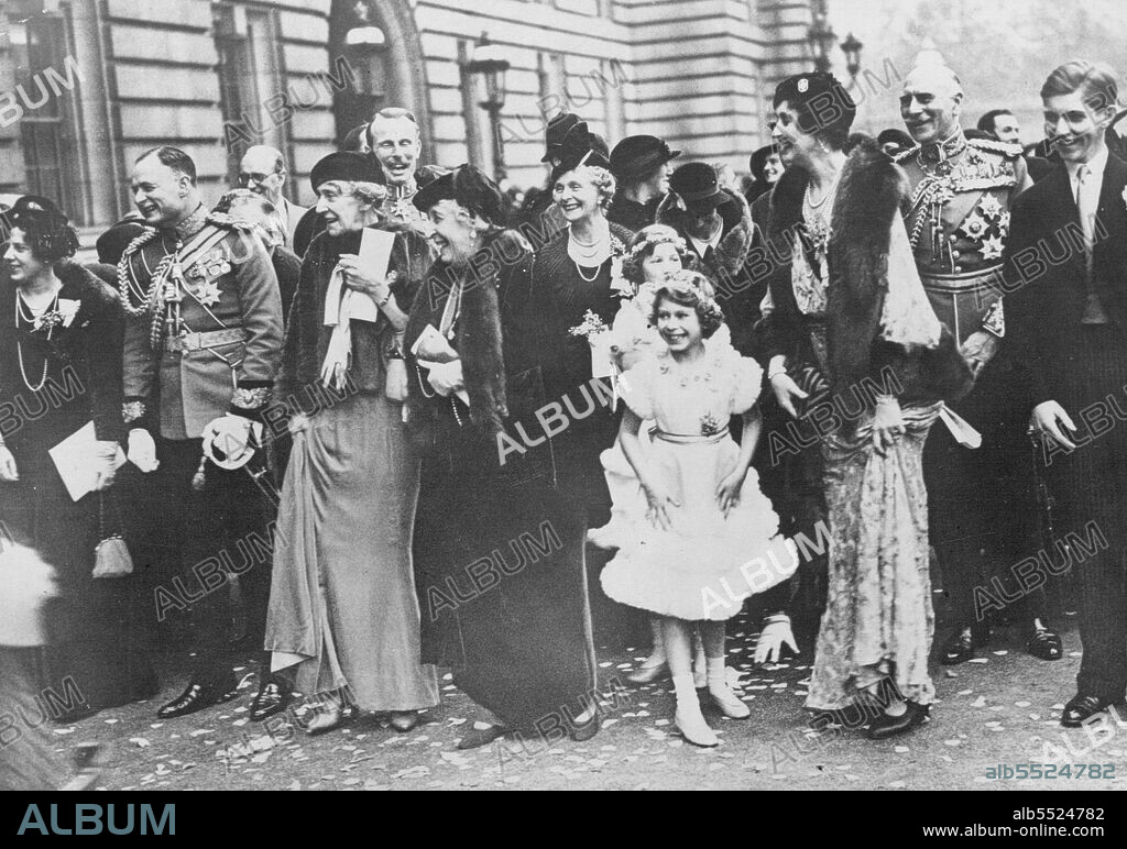 The Royal Wedding Guests Assembled In The Forscourt Of Buckingham Palace, To Bed Farewell To The Duke And Duchess Of Gloucester As They Drove To St. Pancras Station En Route For Their Honymmon -- A happy group watching the bridges and bridegroom leave the Palace.L to R. Lady Maud Carnegie, the Marquess of Cambridge, Princess Marie Louise (behind whom is Lord Carnegie), Princess Helena Victoria, the Countess of Athlane, Princess Elizabeth and behind her, Lady Mary Cambridge, Lady Patricia Ramsay, the Earl of Athlone, and Mr. A. Ramsay. November 6, 1935. (Photo by Sports & General Press Agency Limited).