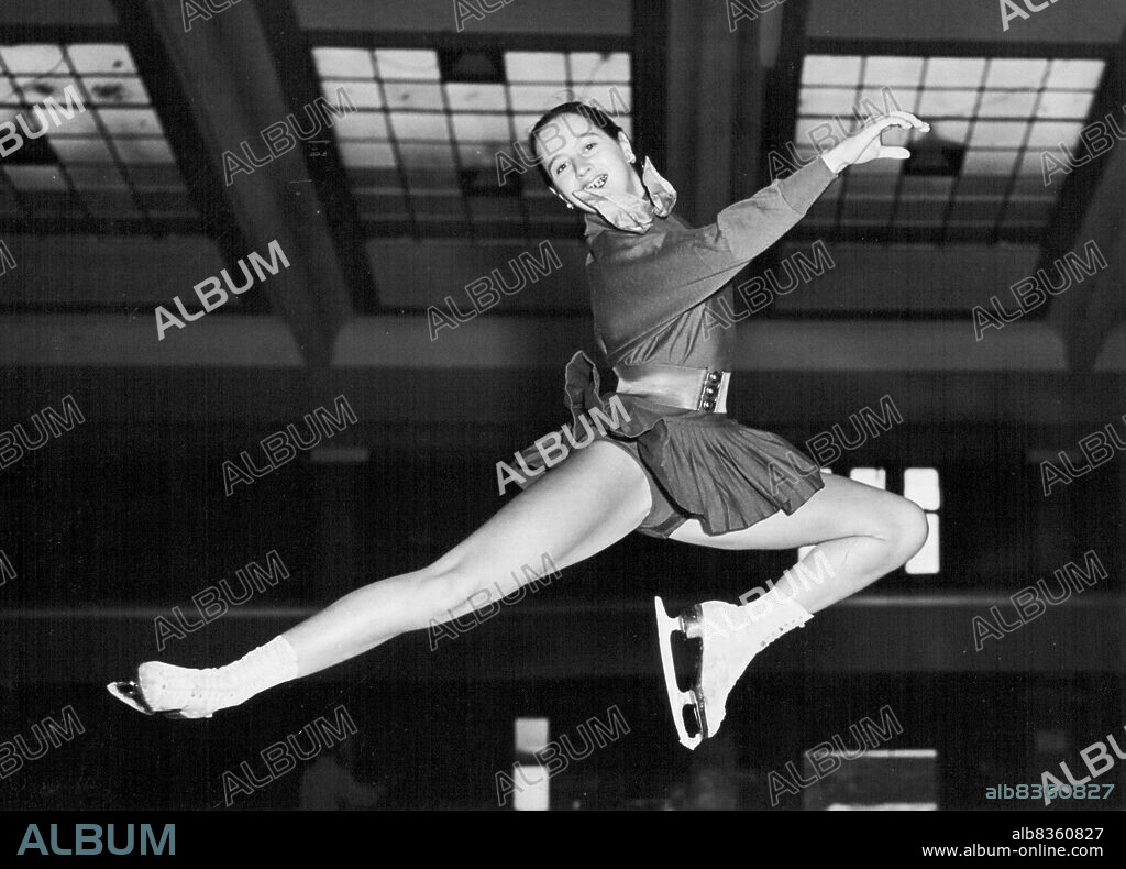 A Champion in Training - Skill and gracedemonstrated by young ice-skating champion Yvonne Sugden seen in action at Streatham Ice Rink where she is training for the British Senior Ladies Figure and Free Skating Championships, being held on Dec. 7th. Among the skaters now in training for the British Senior Ladies Figure and Free Skating Championships, being held at Streatham Ice Rink on December 7th., is young champion Yvonne Sugden of Streatham, who will be 16-years-old on October 14th. Yvonne, the resent title holder, has a special incentive for winning this year's championship, for, having won the title for the last two years, another win will complete her "hat trick". October 07, 1955. (Photo by Fox Photos).