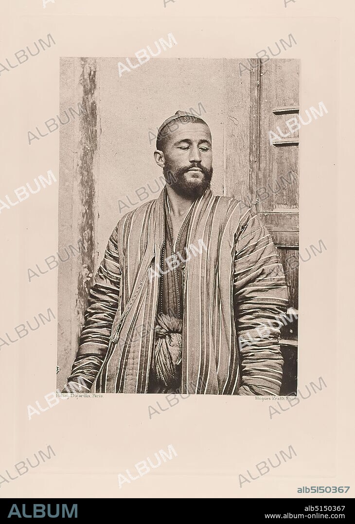 Hachette & Cie, Hugues Krafft, Dujardin, Un Ouzbeg de Kokan en khalat de soie de plusieurs couleurs, from the book A travers le Turkestan Russe, paper, heliogravure, image size: height: 16.90 cm; width: 12.10 cm, travel photography, portrait photography, beard, folk costume, regional costume, man, half-length portrait, facade ,house, building.