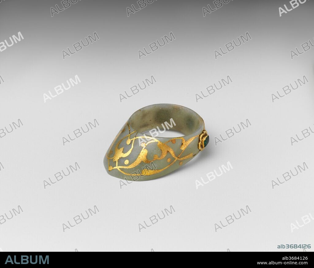 Archer's Thumb Ring. Culture: Turkish. Dimensions: L. 1 1/2 in. (3.8 cm); W. 1 in. (2.5 cm); Wt. 0.4 oz. (11.3 g). Date: 16th-17th century.
A thumb ring provided the archer with a firmer grip of the bowstring. As archery was considered a noble sporting exercise, thumb rings, often carried ostentatiously on strings hung from the belt, were worn as symbols of elevated social status. This example, fashioned in pale green nephrite jade set with gemstones in gold foliate mounts, is typically Ottoman. Similar rings are associated with Sultan Süleyman the Magnificent (r. 1520-66) and his immediate successors.