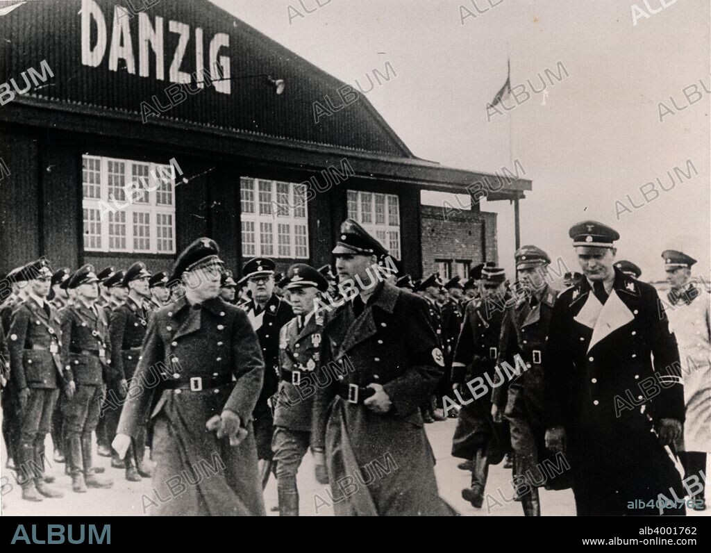 Nazi Deputy Führer Rudolf Hess visiting the free city of Danzig, 1930s. Hess (1894-1987) pictured with local Nazi leaders Albert Forster (1902-1952) and Arthur Greiser (1897-1946). Danzig (modern Gdansk) was given the status of a semi-autonomous city-state separate from Germany and the newly independent Poland by the Treaty of Versailles in 1920. The majority of the population was German and after the Nazis came to power in Germany in 1933, Danzig's government was taken over by the local Nazi Party. Hitler's demand to annex Danzig in 1938 led to an increase in tensions between Poland and Germany, with the latter invading in 1939. Forster and Greiser were both sentenced to death for war crimes in occupied Poland during the Second World War.
