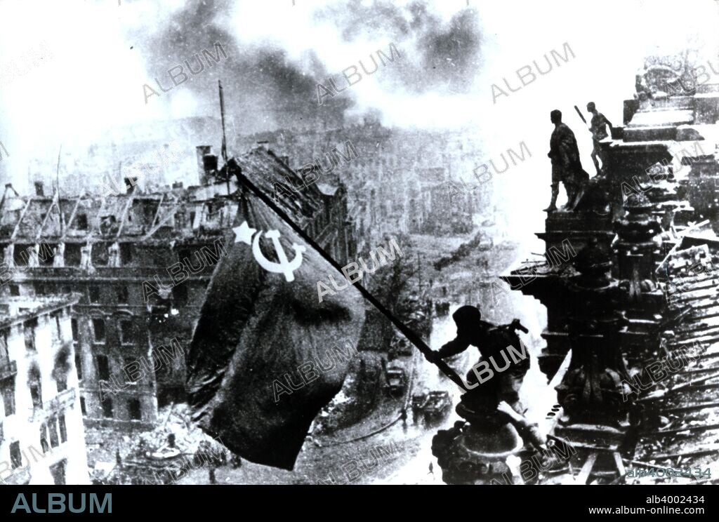 Raising a flag over the Reichstag, 2 May 1945. Taken during the Battle of Berlin 1945, by Yevgeny Khaldei. It depicts several Soviet troops raising the flag of the Soviet Union atop the German Reichstag building. The photograph was instantly popular, being reprinted in thousands of publications. It came to be regarded around the world as one of the most significant and recognizable images of the war.