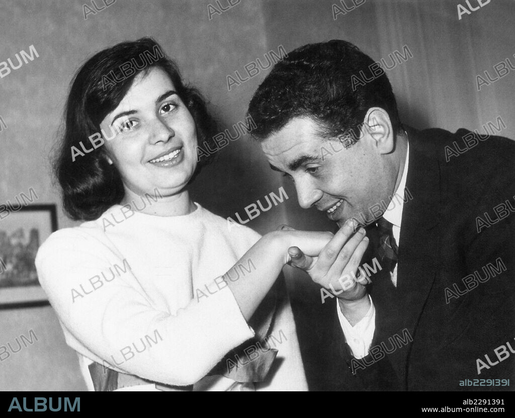 Enzo Tortora with his wife Pasqualina Reillo. Italian TV presenter and journalist Enzo Tortora kissing his wife Pasqualina Reillo's hand. Italy, 1957.