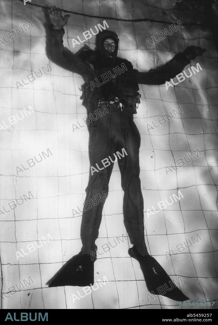 Frogman -- A frogman swimming under water recently at the Amphibious School, Royal Marines, Fort Cumberland, Hampshire, England.
These Frogmen, used extensively during the war to damage enemy shipping, were recently used in the search for the child believed to be drowned in a canal. Notice the paddles on the feet, from which the frogmen derive their name, and with which they are able to produce extremely fast swimming on and under the water. February 02, 1950. (Photo by Associated Press Photo).