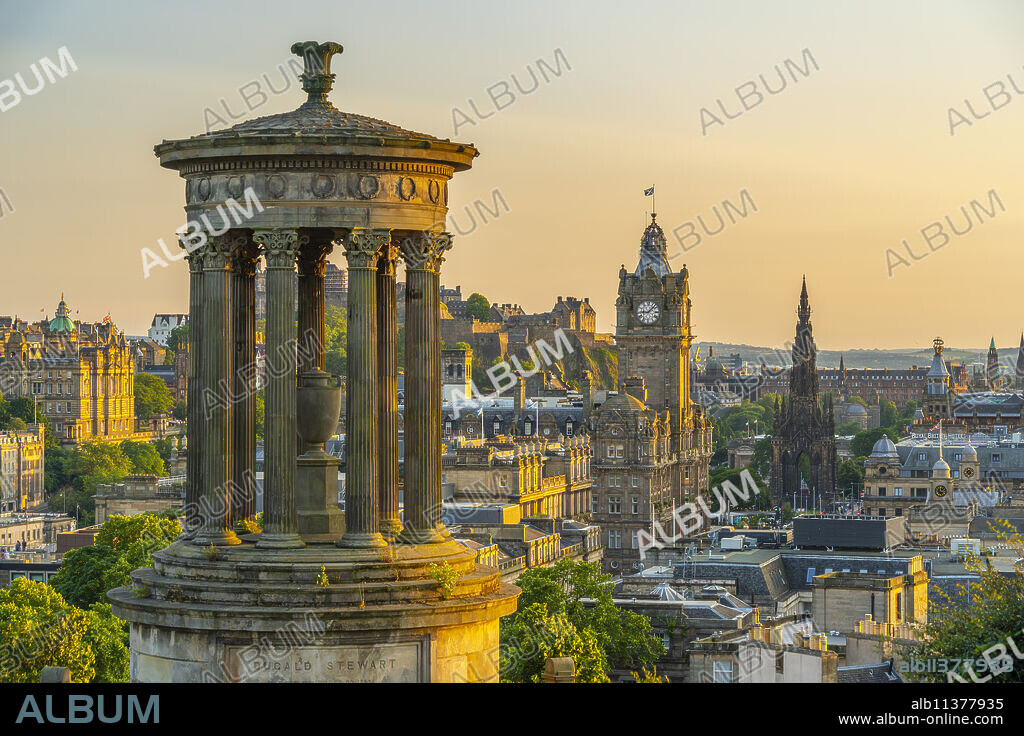 View of Edinburgh Castle, Balmoral Hotel and Dugald Stewart monument from Calton Hill at golden hour, UNESCO World Heritage Site, Edinburgh, Lothian, Scotland, United Kingdom, Europe.