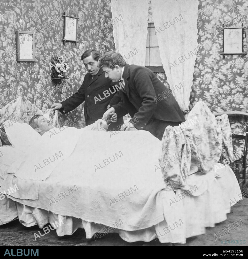 Magic lantern slide circa 1900.Victorian.Social History. Image from a slide presentation entitled In His step or In jesus Name.  A sick man in his bed wioth the minister and a doctor holding his hand before he dies.