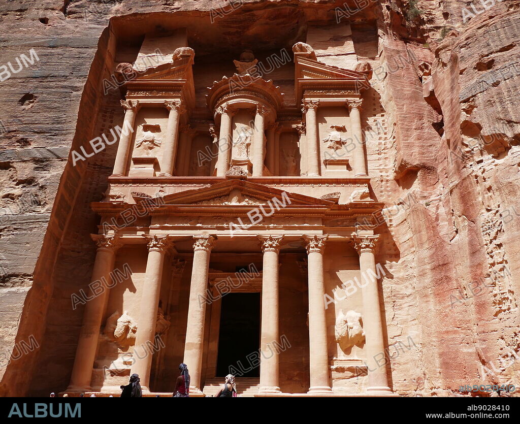 Al-Khazneh (The Treasury) a temple in the ancient Nabatean Kingdom city of Petra, Jordan. The structure was carved out of a sandstone rock face and is believed to have been the mausoleum of the Nabatean King Aretas IV in the 1st century AD. It is one of the most popular tourist attractions in both Jordan and the region. In 1812, the city of Petra and Al-Khazneh was rediscovered by Swiss explorer Johann Ludwig Burckhardt.