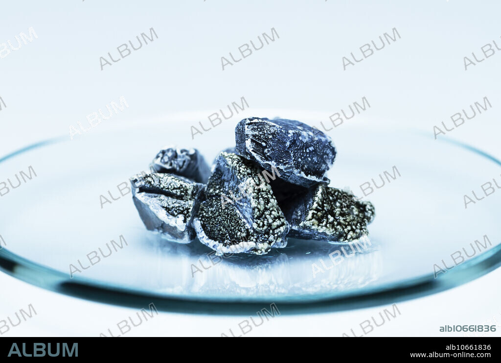Chunks of potassium metal (K) in a watch glass.