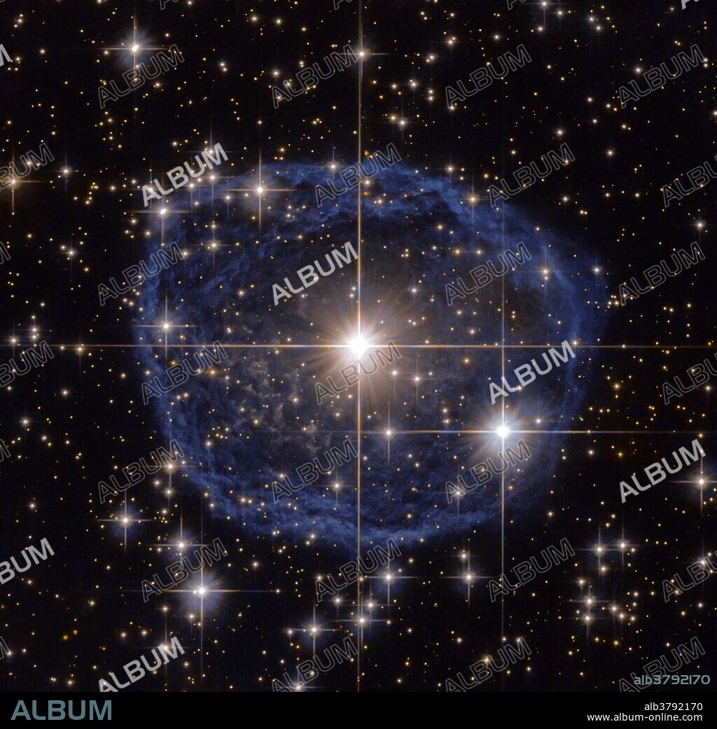 At the center of this Hubble Space Telescope image is a Wolf-Rayet star known as WR 31a, located about 30 000 light-years away in the constellation of Carina (The Keel). The blue bubble appearing to encircle WR 31a is a Wolf-Rayet nebula--an interstellar cloud of dust, hydrogen, helium and other gases. Created when stellar winds interact with the outer layers of hydrogen ejected by WolfÂ­Rayet stars, these nebulae are frequently ring-shaped or spherical. The bubble is expanding at a rate of around 220,000 kilometers per hour. WR 31a will eventually end its life as a spectacular supernova, and the stellar material expelled from its explosion will later nourish a new generation of stars and planets.